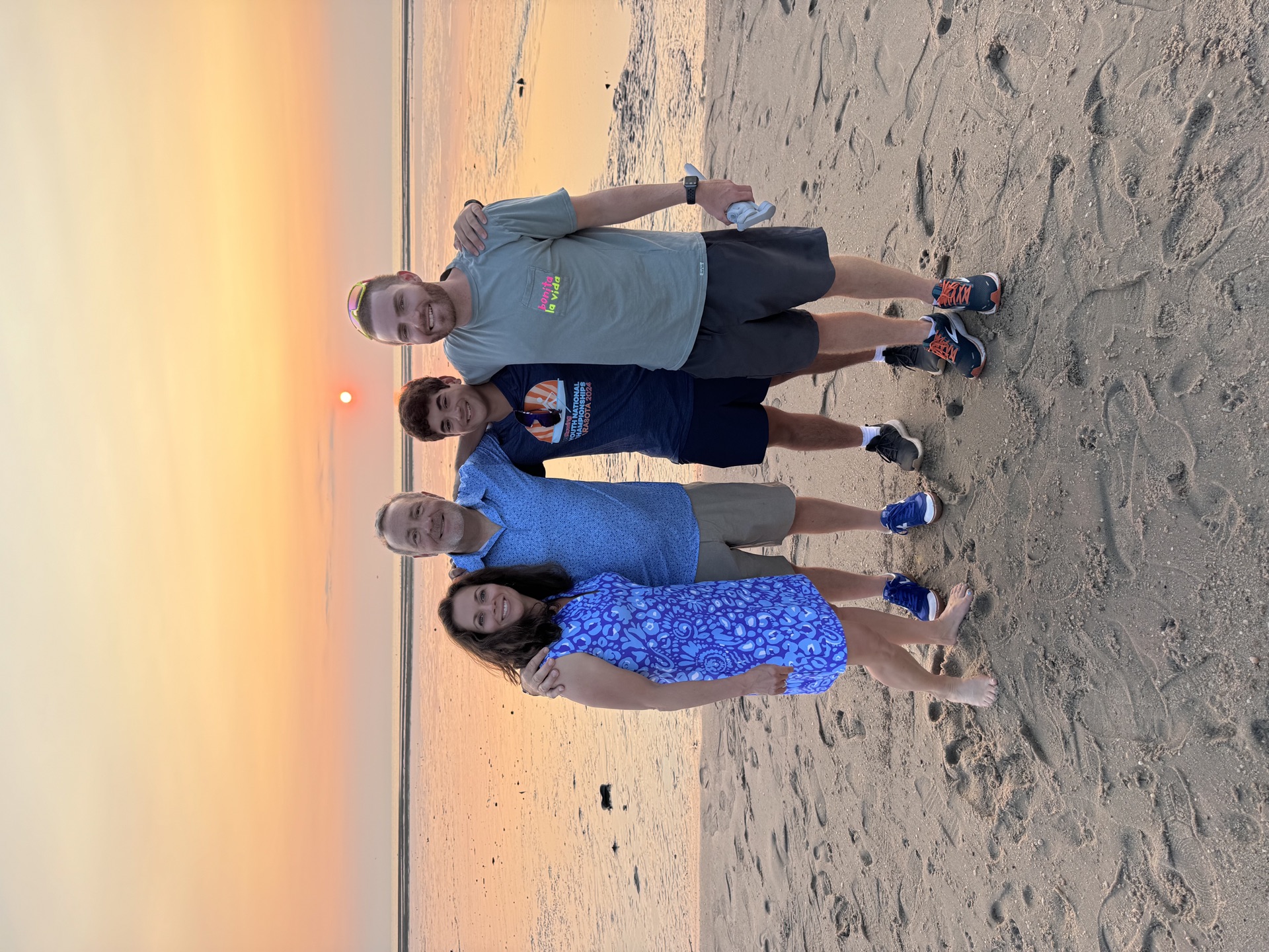 Family together at beach during sunset