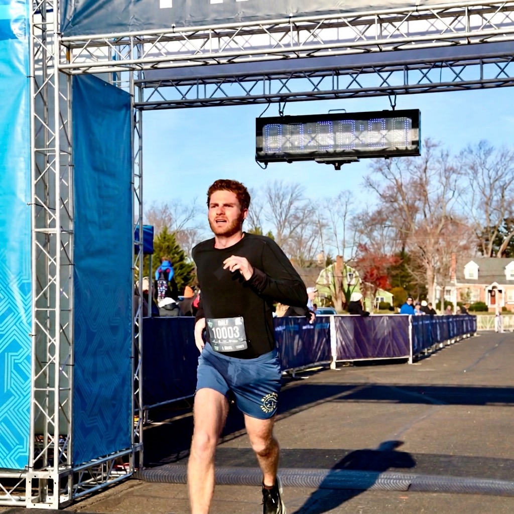 Sam crossing the finish line