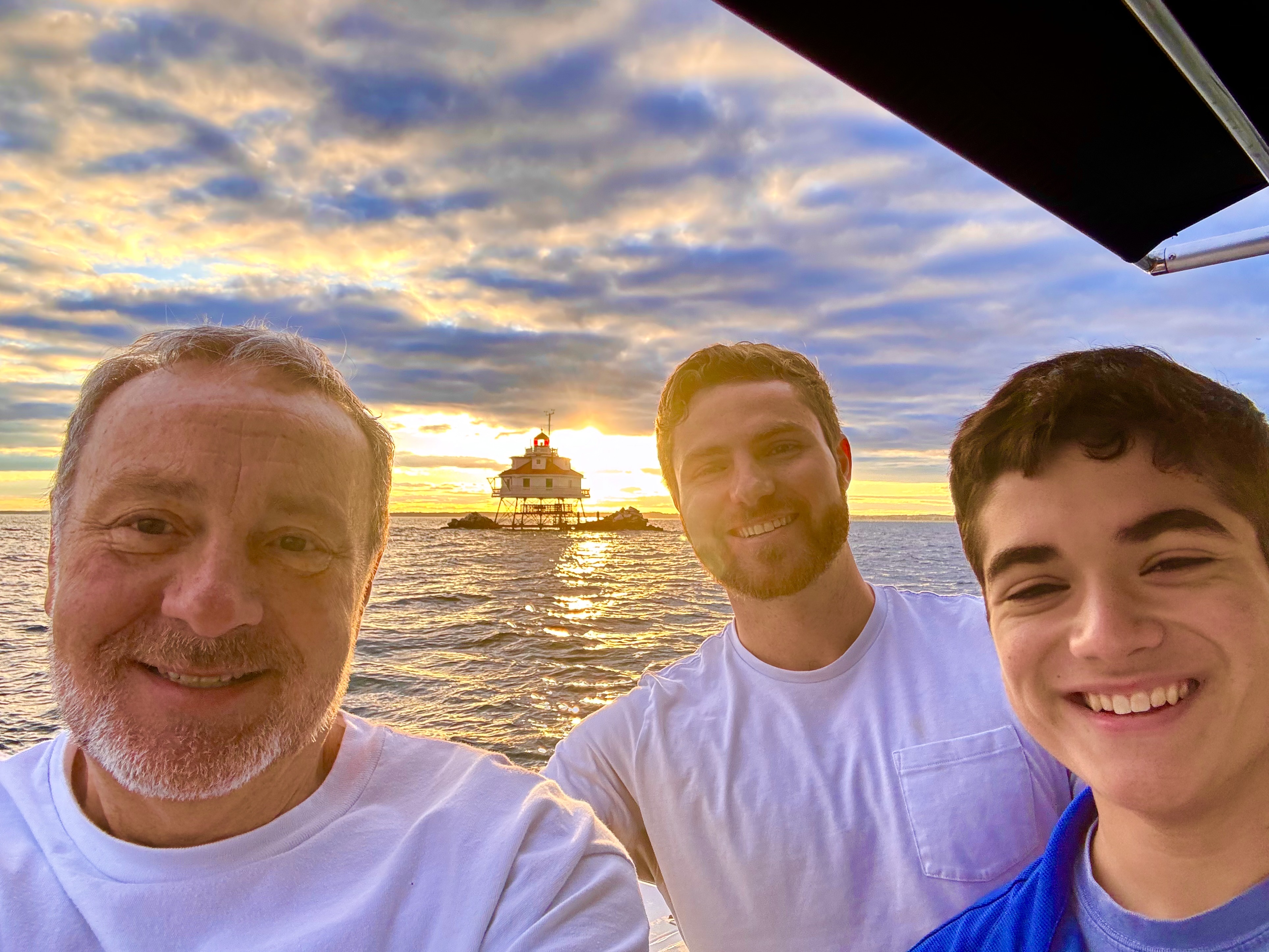 Frank, Joey, and Sam at sunset by a lighthouse