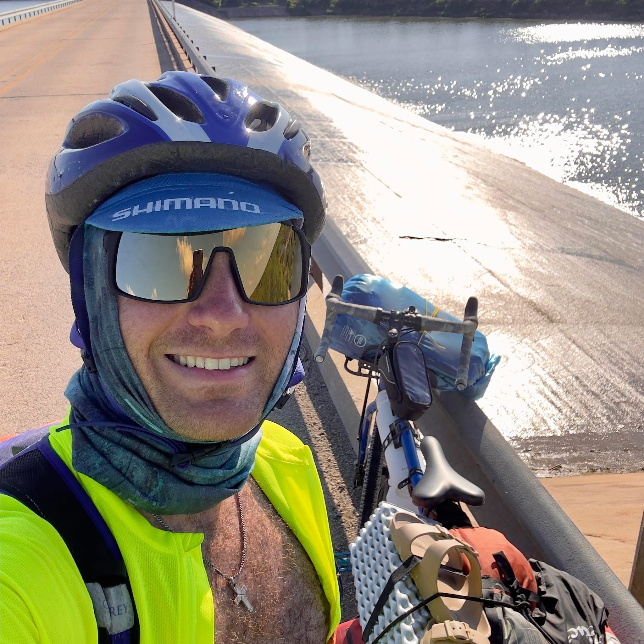 Sam biking across a bridge